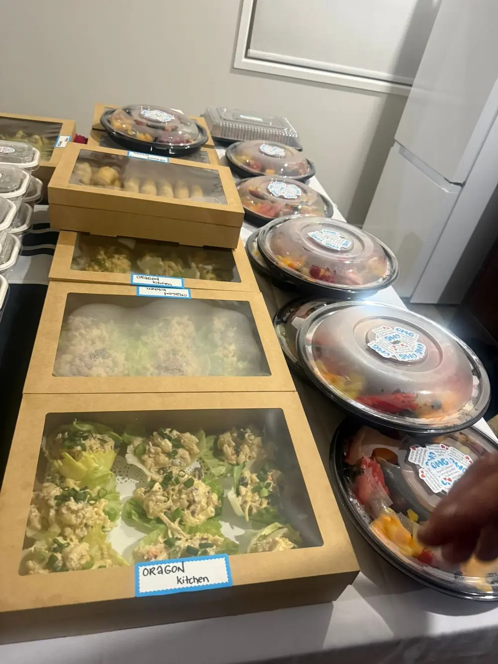 Prepared catering boxes and platters arranged across a table