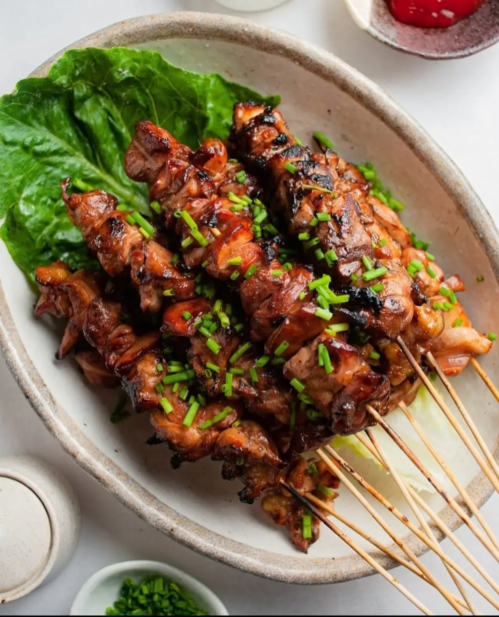 Glazed chicken skewers arranged on a serving plate